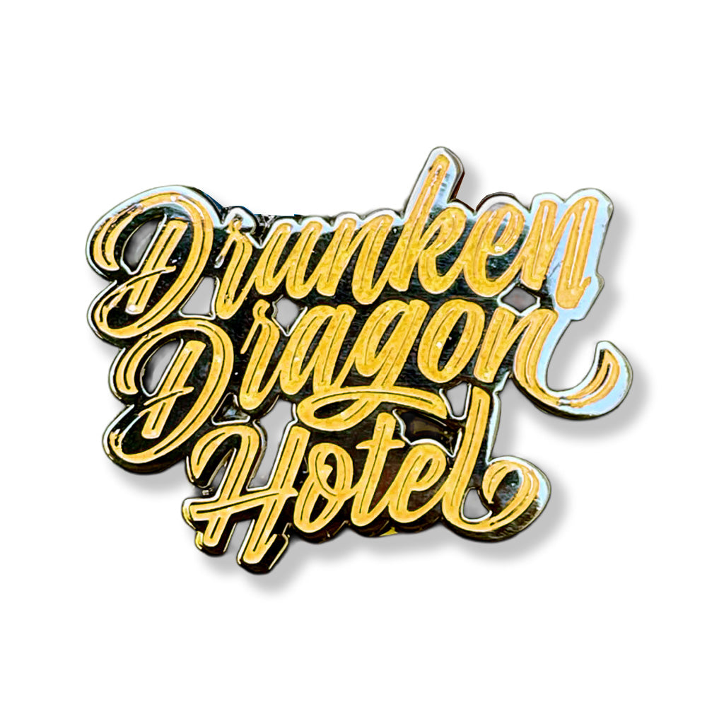 Drunken Dragon Hotel Pin Black Yellow Letters 1.3"